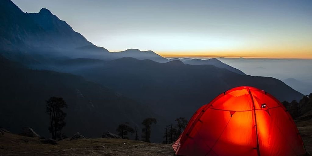 adventurous people camping in scenic mountain landscape