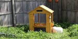 a small wooden house sitting in the middle of a yard